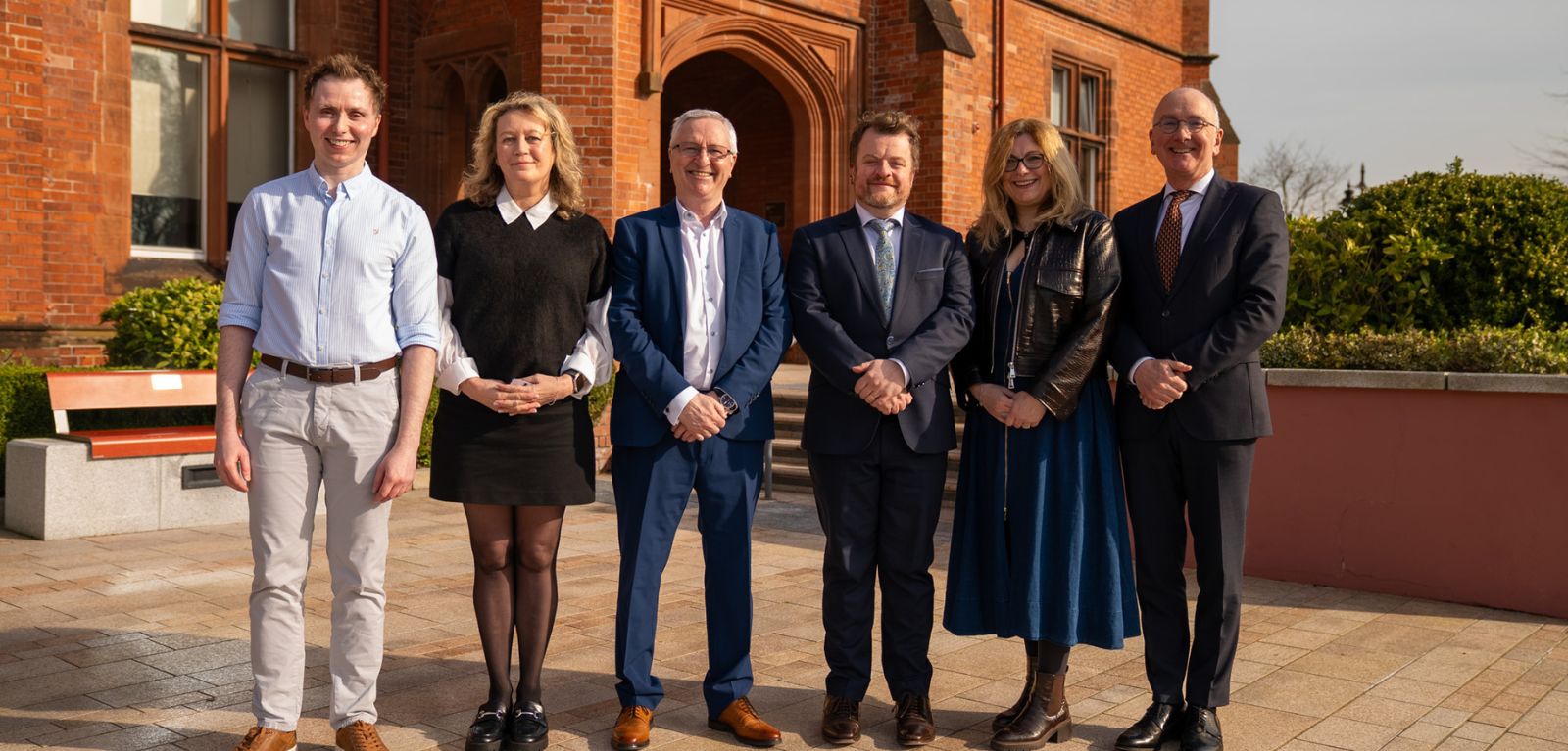 Group of people standing in a row at Riddell Hall
